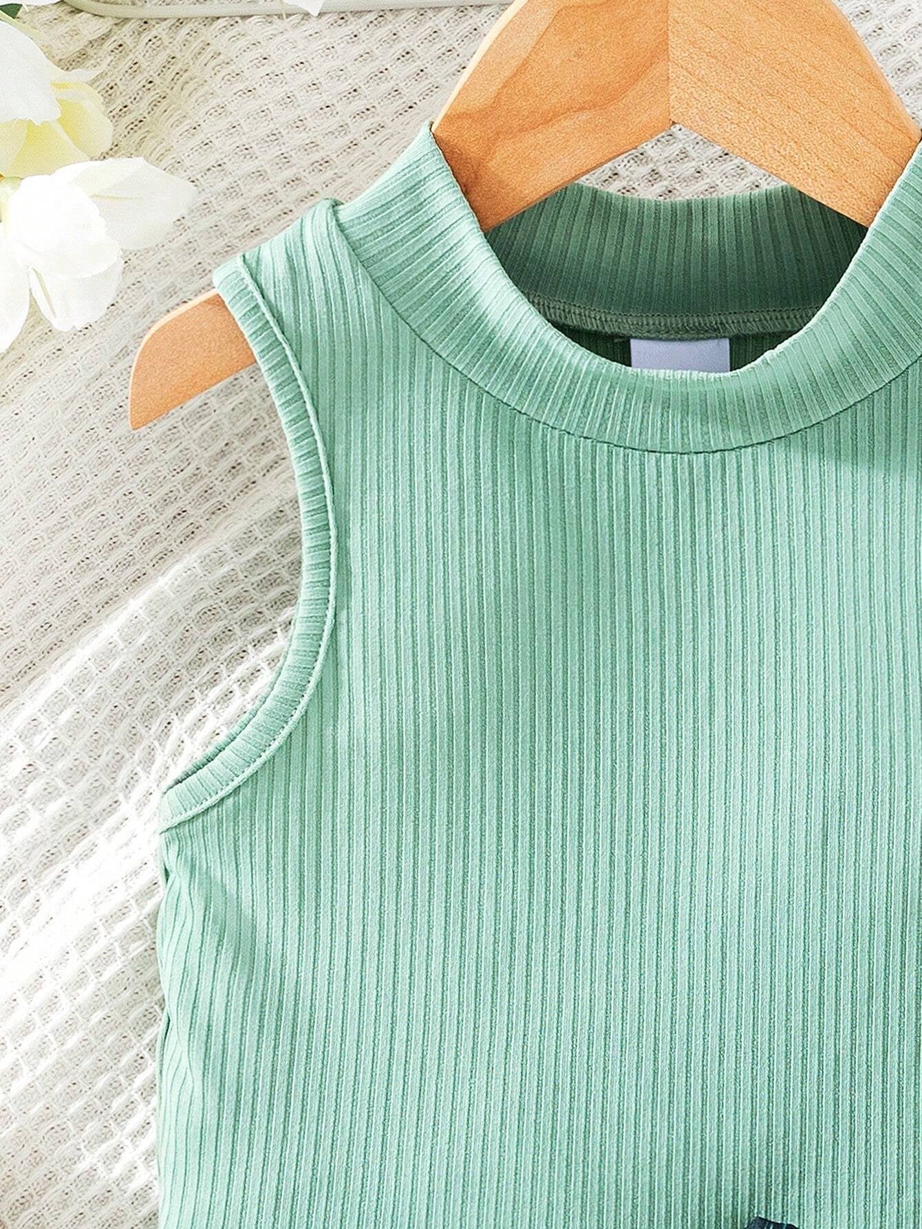 Detalle de la blusa verde pastel acanalada.