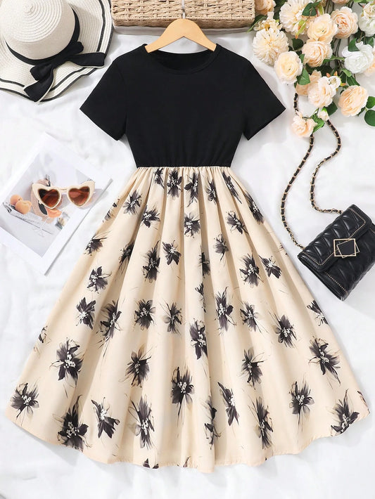 Detalle del vestido elegante para niña negro y beige mostrando textura y estampado