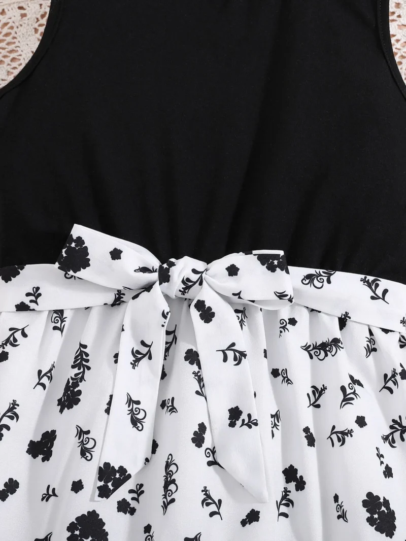 Detalle del lazo y cinturón ajustable del vestido midi blanco y negro con cinturón para niña.
