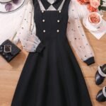 Vestido negro elegante con mangas de gasa y doble botonadura, ideal para niñas.