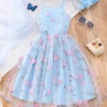 Vestido azul con tul bordado y apliques para niña, vista frontal mostrando tirantes finos y falda campana.