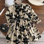Vestido floral para niñas con cuello alzado y manga larga en fondo beige.